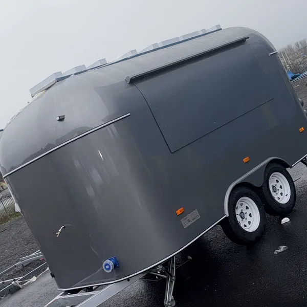 The metallic grey Airstream in daylight, hatch closed, ready to go